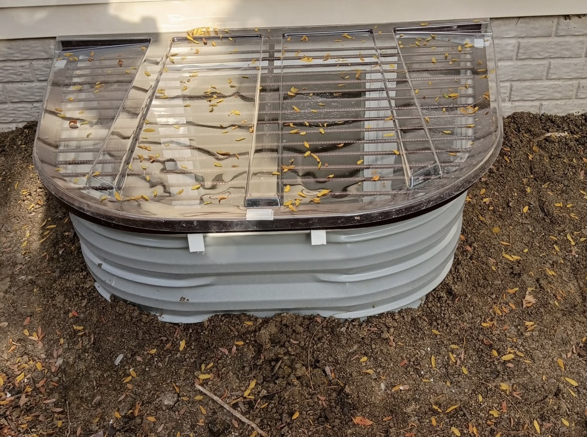 Finished egress window well with clear cover in Bettendorf, Iowa