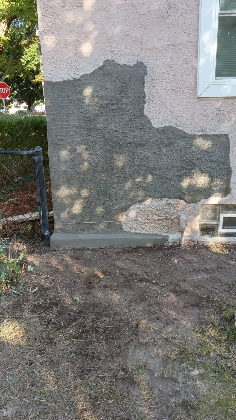 Repaired stucco wall on an older Davenport home with the texture matched to the existing finish