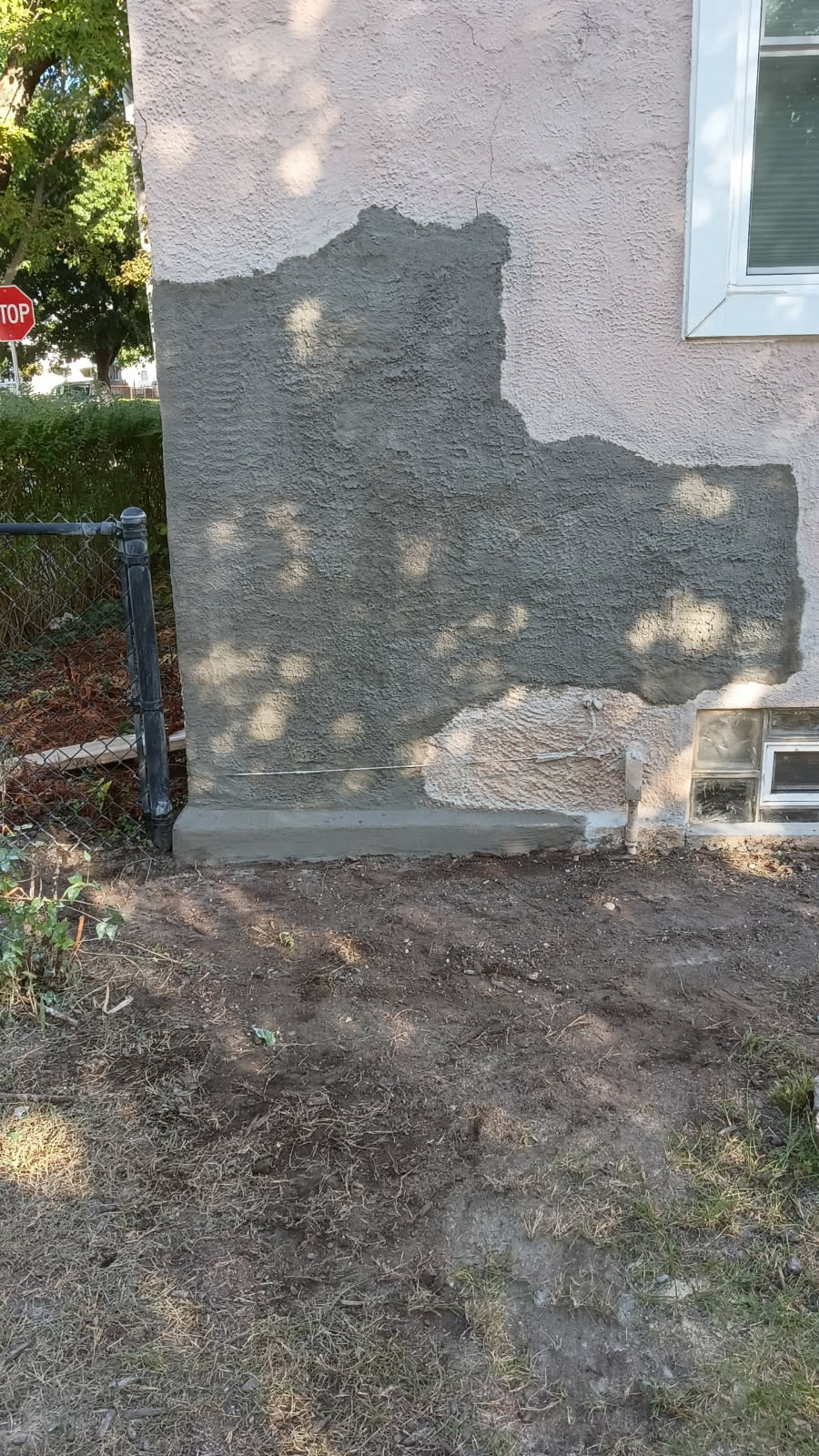 Repaired stucco wall on an older Davenport home with the texture matched to the existing finish