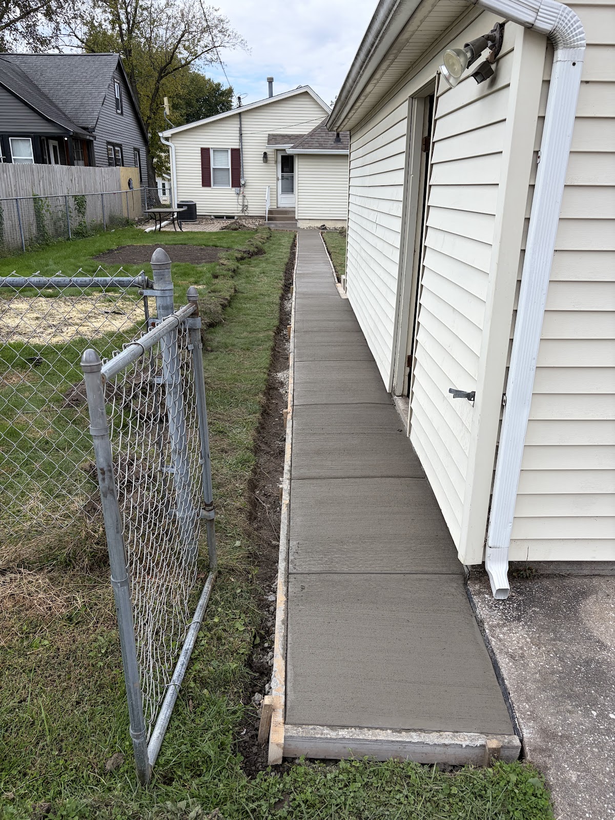 Finished concrete sidewalk along the side of a Moline home