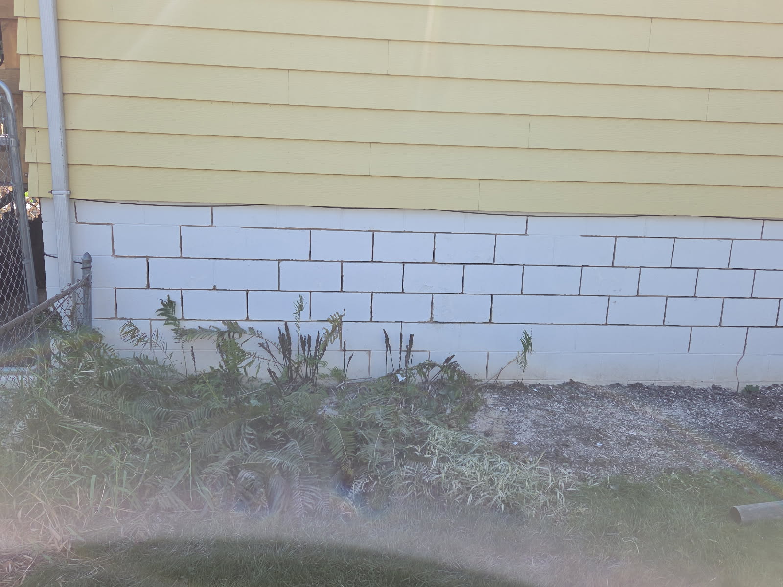 Foundation and regraded bed along the side of the house after the drainage work