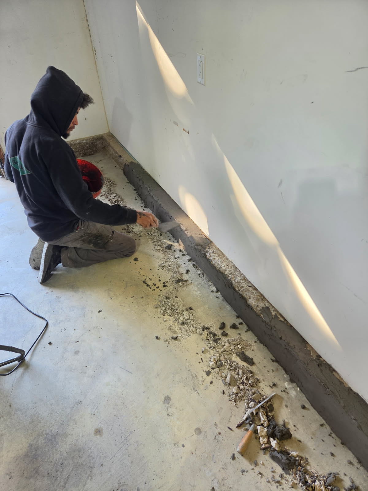 Crew member bonding new repair material to the prepared stem wall