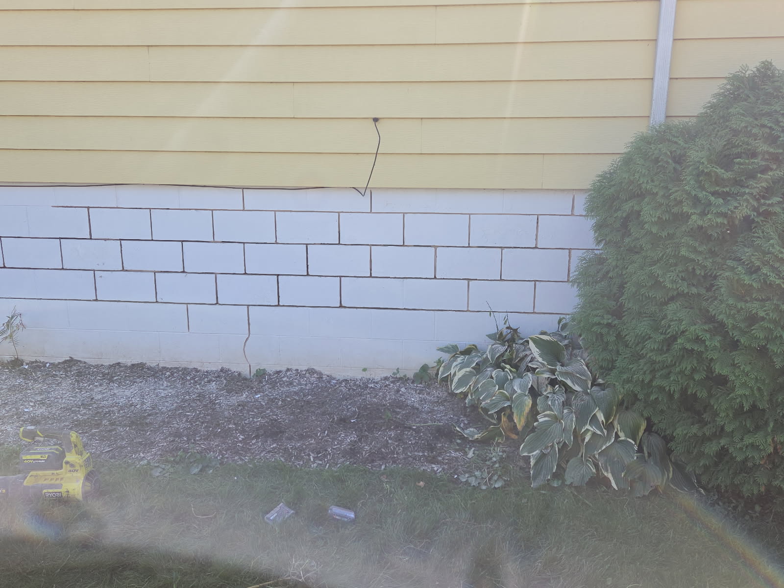 Foundation wall with regraded soil directing water away from the home
