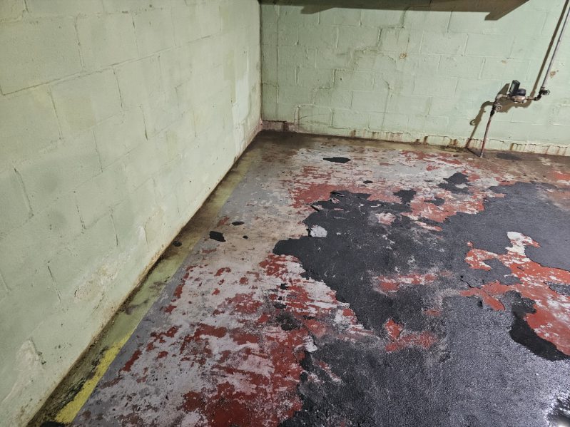 Basement block wall and floor in Bettendorf at the start of the waterproofing installation