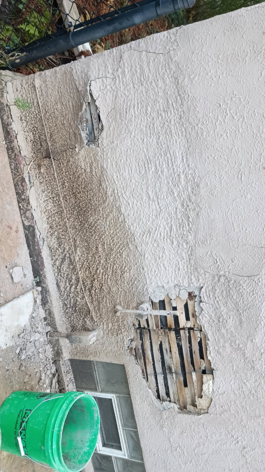 New stucco applied over the prepared wall section