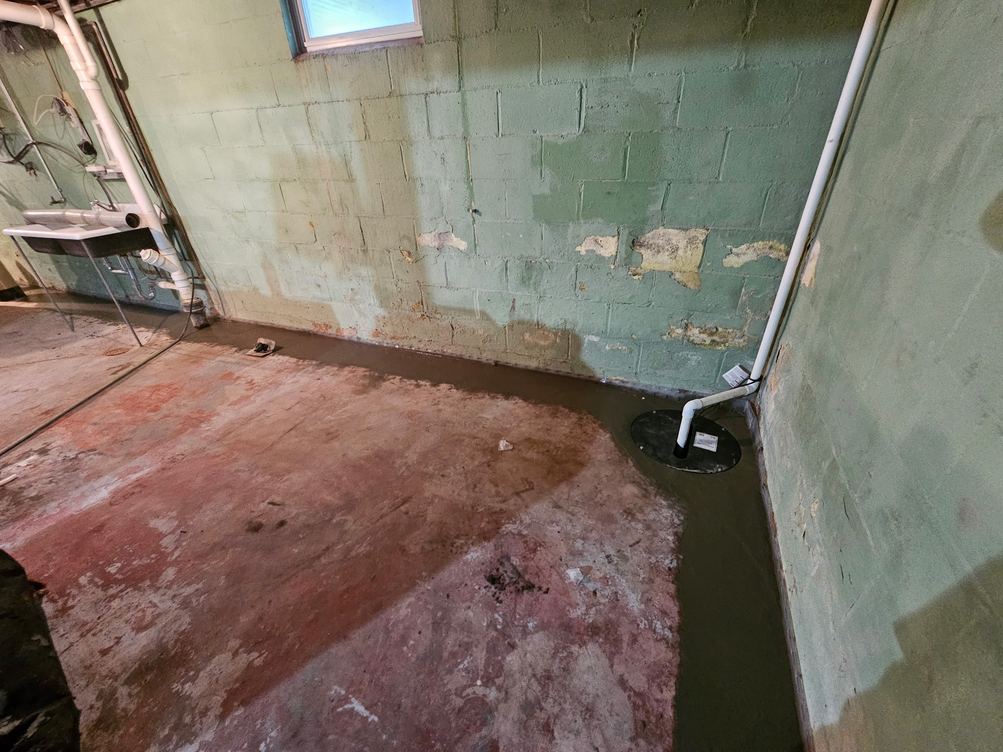 Bettendorf basement during the waterproofing and foundation wall stabilization project