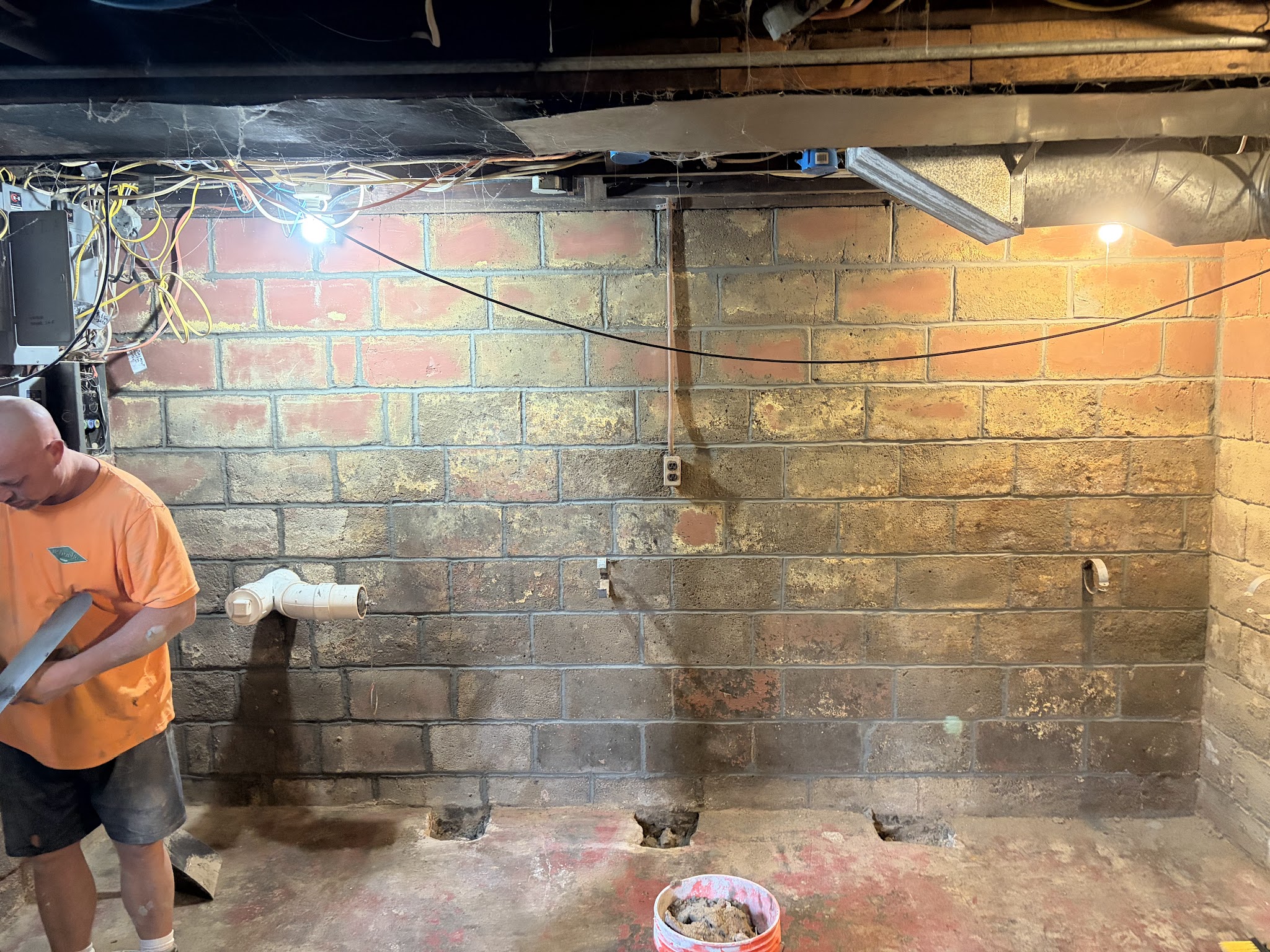 Steel foundation braces installed along the block wall during tuckpointing