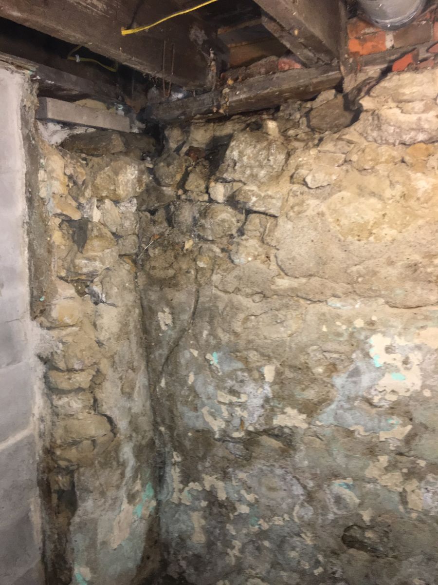 A deteriorated corner under the sill plate, where water and time have done the most damage.